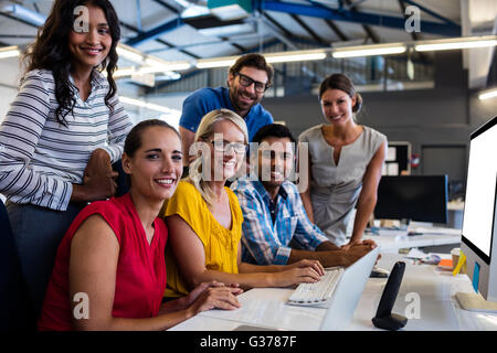 Casual business team smiling at camera Stock Photo