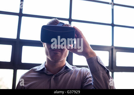 Businessman using virtual reality device Stock Photo