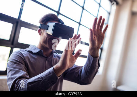 Businessman using virtual reality device Stock Photo