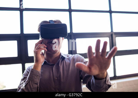 Businessman using virtual reality device Stock Photo