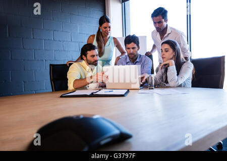 Coworkers working together on a laptop Stock Photo