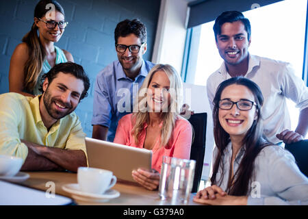 Group of creative businessmen using a tablet computer Stock Photo