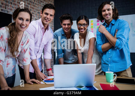 Group of designers working on a computer Stock Photo