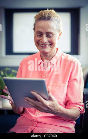 Senior woman using digital tablet Stock Photo