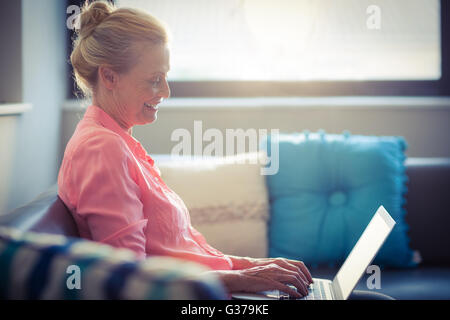 Senior woman using laptop Stock Photo
