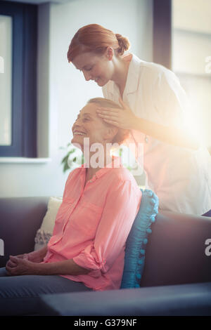 Female nurse giving head massage to woman Stock Photo - Alamy