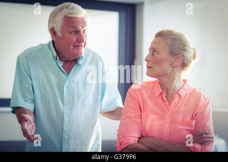 Senior man shouting on senior woman Stock Photo