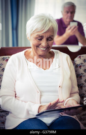 Senior woman using digital tablet Stock Photo