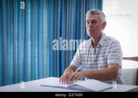 Blind man reading a braille book Stock Photo