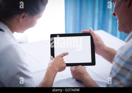 Senior man and female doctor using digital tablet Stock Photo