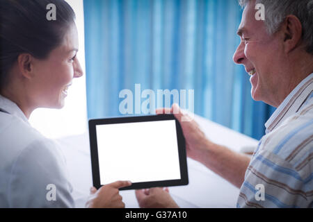 Senior man and female doctor using digital tablet Stock Photo