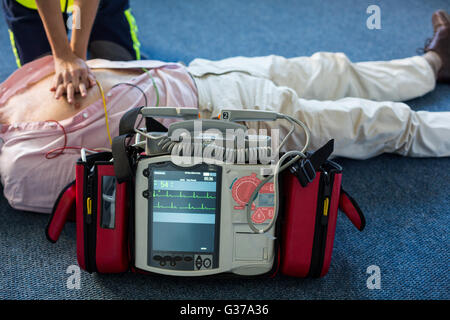 Paramedic using an external defibrillator during cardiopulmonary resuscitation Stock Photo