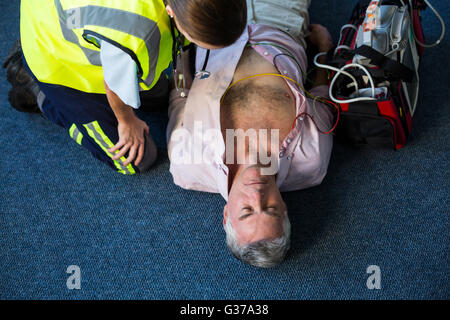 Paramedic using an external defibrillator during cardiopulmonary resuscitation Stock Photo