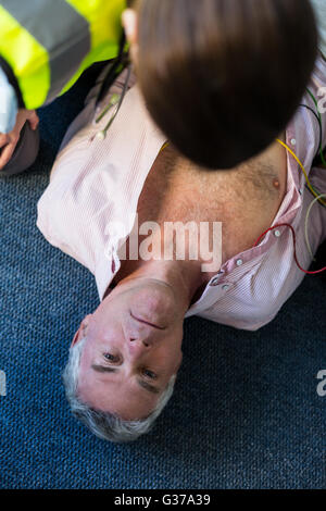 Paramedic using an external defibrillator during cardiopulmonary resuscitation Stock Photo