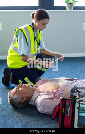 Paramedic using an external defibrillator during cardiopulmonary resuscitation Stock Photo