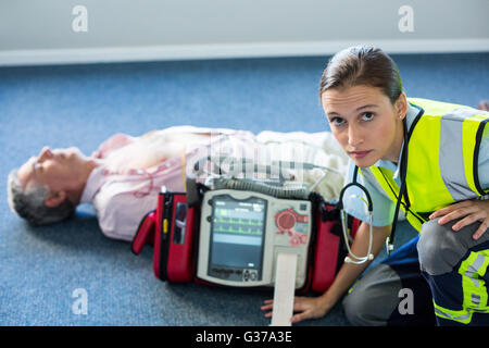 Paramedic using an external defibrillator during cardiopulmonary resuscitation Stock Photo