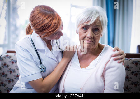 Doctor consoling senior woman Stock Photo