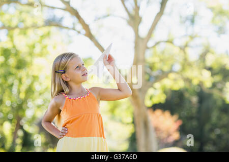 Young girl playing with a paper plane Stock Photo