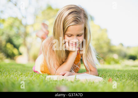 Young girl reading book in park Stock Photo