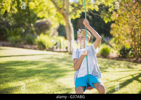 Boy swinging on swing Stock Photo