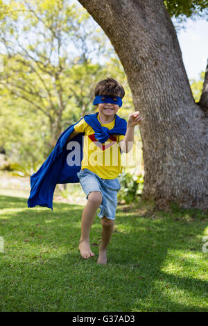 Young boy pretending to be a superhero Stock Photo