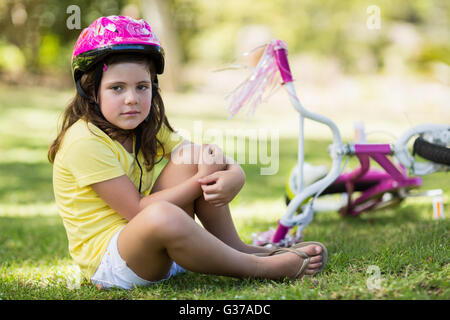 Young girl getting injured after falling from bicycle Stock Photo