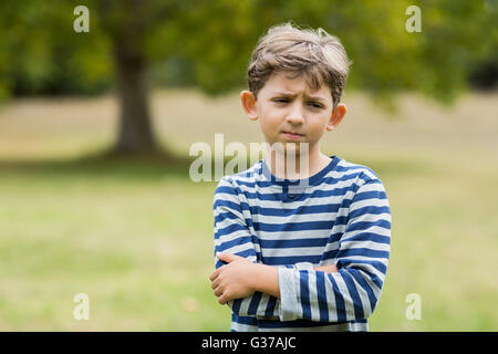 Portrait of upset boy standing with arms crossed Stock Photo