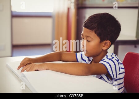 School boy memorizing the lesson in classroom Stock Photo