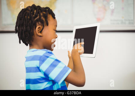School boy using a digital tablet in classroom Stock Photo