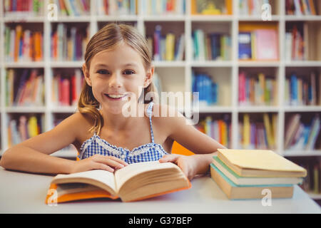 Smiling school girl in library Stock Photo - Alamy