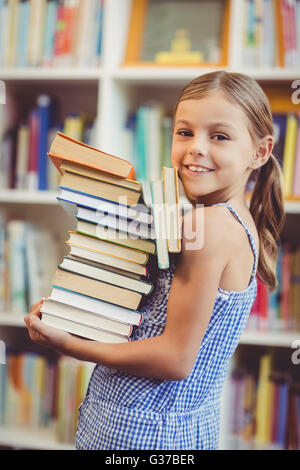 School Girl holding books standing at school Stock Photo - Alamy