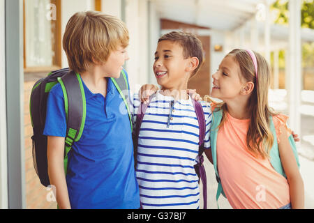School kids talking to each other in school corridor Stock Photo
