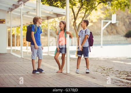 School kids talking to each other in school corridor Stock Photo
