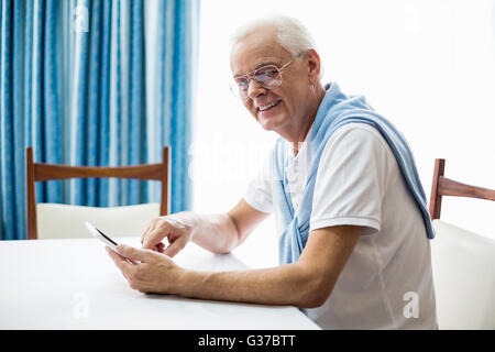 Senior man using a tablet Stock Photo
