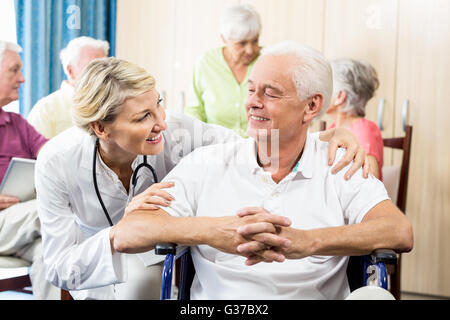 Senior man sitting in a wheelchair Stock Photo