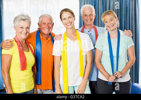 Instructor and seniors with stretching bands Stock Photo