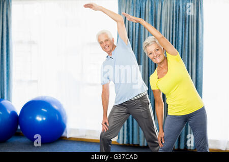 Seniors doing sport exercises Stock Photo