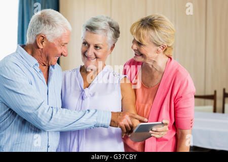 Seniors pointing on smartphone Stock Photo