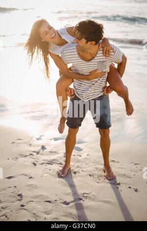 Man giving woman piggyback ride Stock Photo