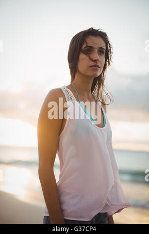 Beautiful woman standing on the beach Stock Photo