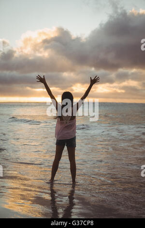 Beautiful woman standing on the beach Stock Photo - Alamy