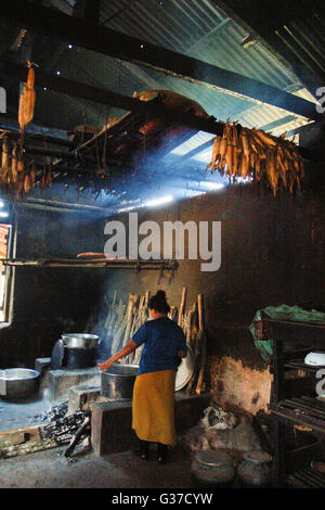 Women Warming by the hearth fire in rural Myanmar Burma, Kengtung, Kyaingtong Stock Photo