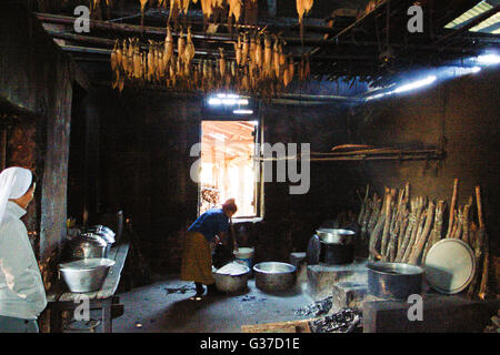 Women Warming by the hearth fire in rural Myanmar Burma, Kengtung, Kyaingtong Stock Photo