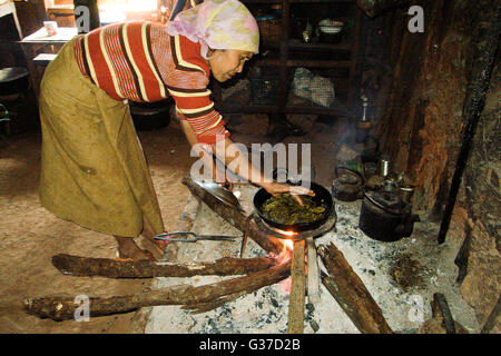 Women Warming by the hearth fire in rural Myanmar Burma, Kengtung, Kyaingtong Stock Photo