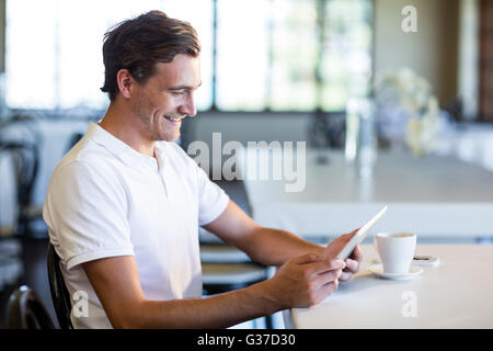 Happy man using digital tablet Stock Photo