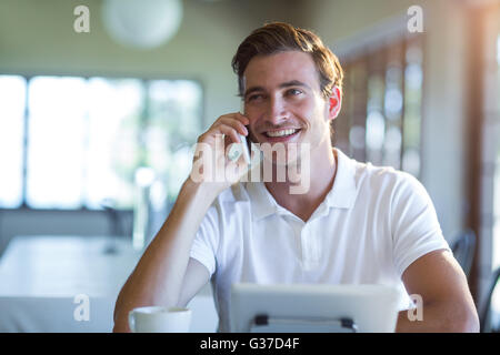 Smiling man talking on mobile phone Stock Photo