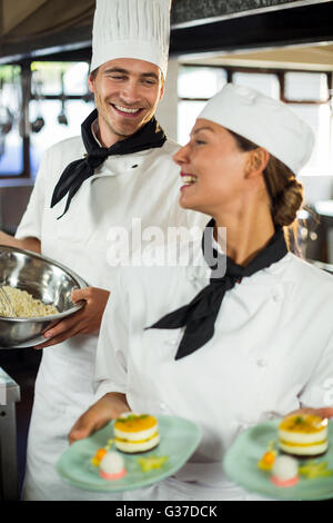 Close-up of chefs smiling while working in kitchen Stock Photo