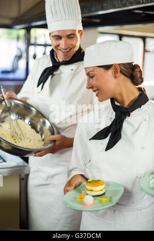 Close-up of chefs smiling while working in kitchen Stock Photo