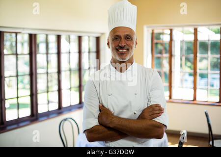 Portrait of smiling chef standing with arms crossed Stock Photo