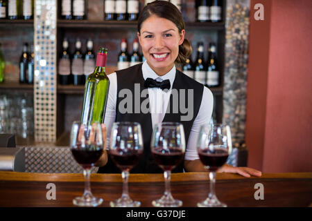 Four glasses of red wine ready to serve on bar counter Stock Photo